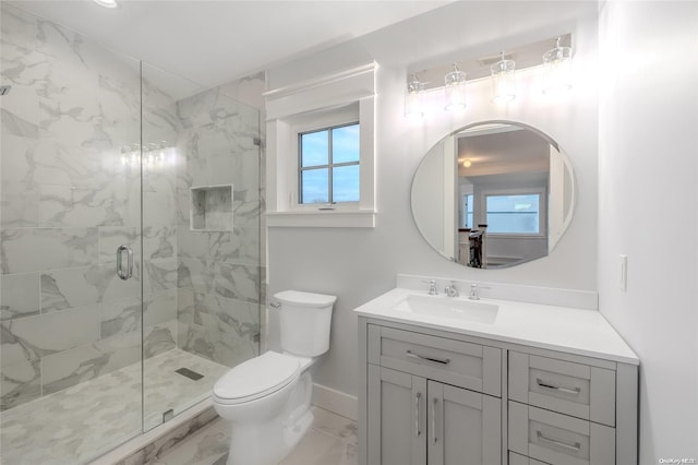 bathroom with vanity, toilet, and a shower with door