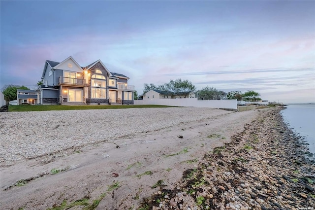 exterior space with a balcony and a water view