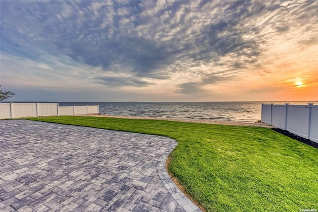 yard at dusk with a water view