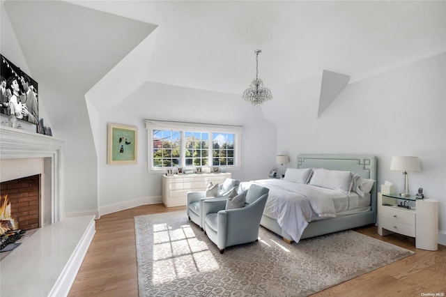 bedroom with light hardwood / wood-style flooring and an inviting chandelier