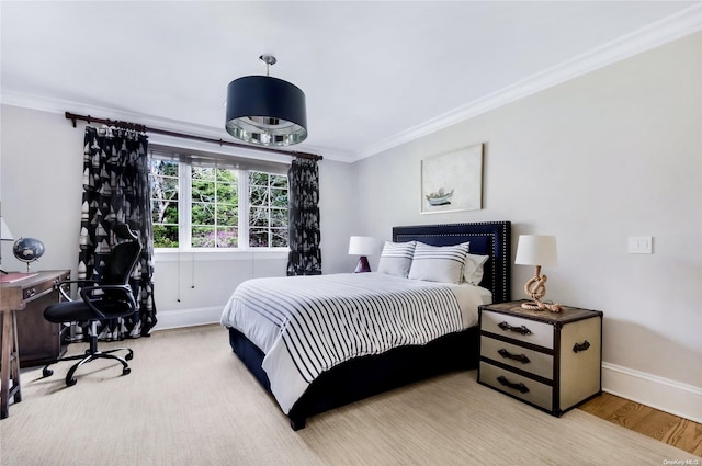 bedroom with ornamental molding and light hardwood / wood-style flooring