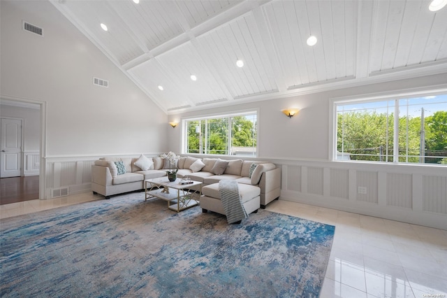 living room with wooden ceiling, light tile patterned floors, a healthy amount of sunlight, and high vaulted ceiling