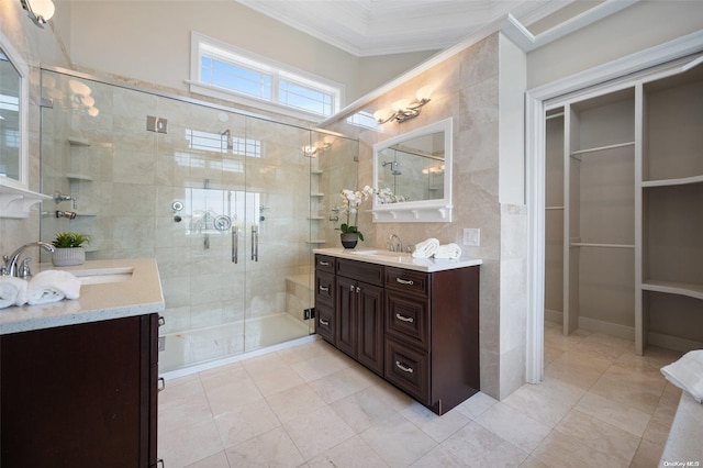 bathroom featuring tile patterned floors, vanity, an enclosed shower, and ornamental molding