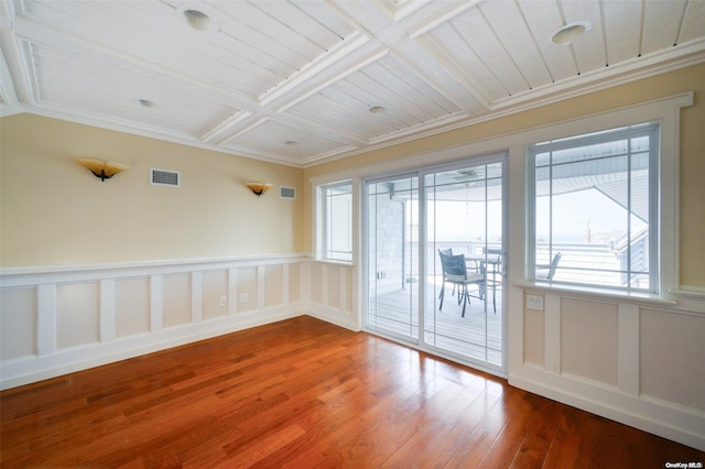 unfurnished room featuring hardwood / wood-style floors, coffered ceiling, and ornamental molding