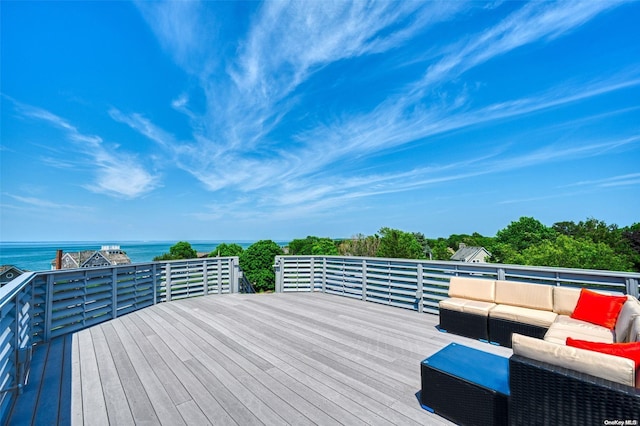 wooden deck featuring an outdoor living space and a water view