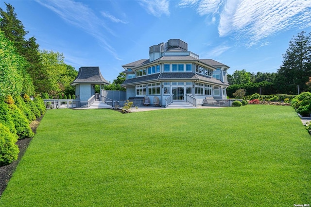 rear view of property with a yard