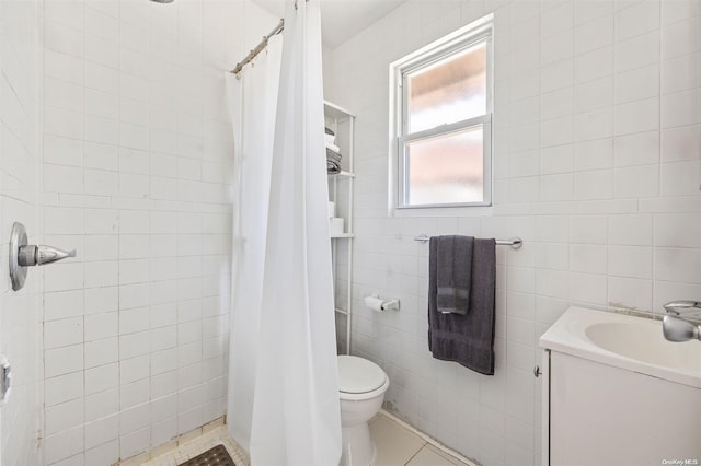 bathroom featuring a shower with curtain, tile patterned floors, toilet, vanity, and tile walls