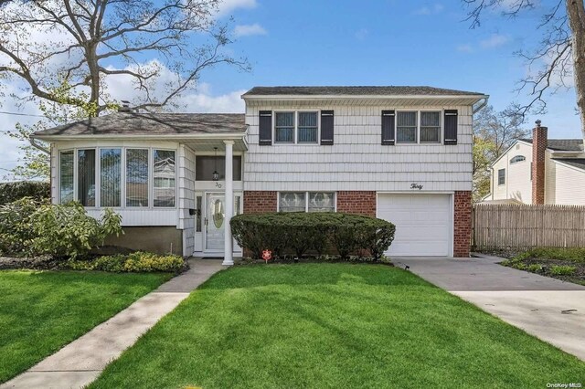 30 Oakwood Ln, Plainview, NY 11803 - tri-level home with a garage and a front yard