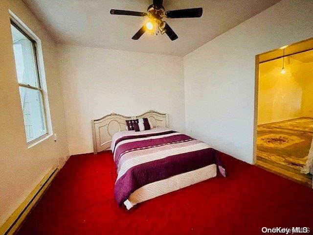 bedroom with carpet flooring, baseboard heating, ceiling fan, and lofted ceiling