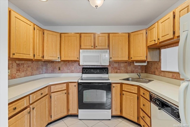 kitchen featuring light brown cabinets, white appliances, sink, and light tile patterned floors