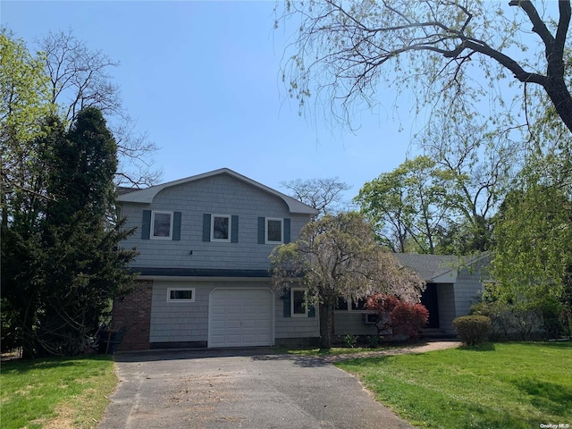 view of front of property featuring a garage and a front lawn