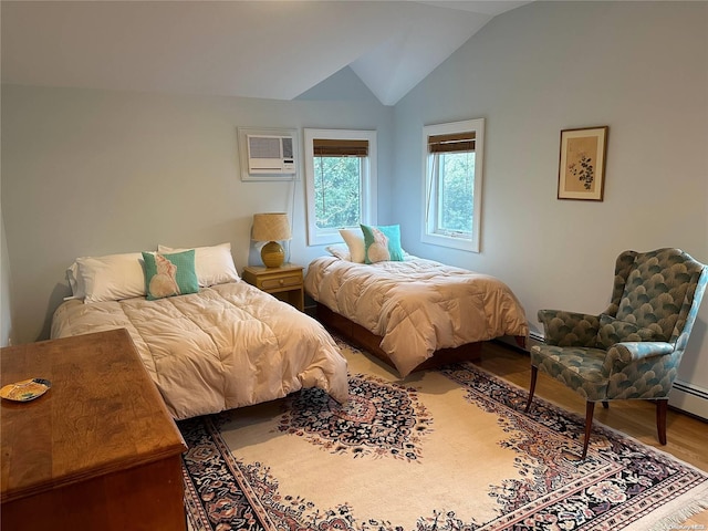 bedroom with wood-type flooring, a wall unit AC, and vaulted ceiling