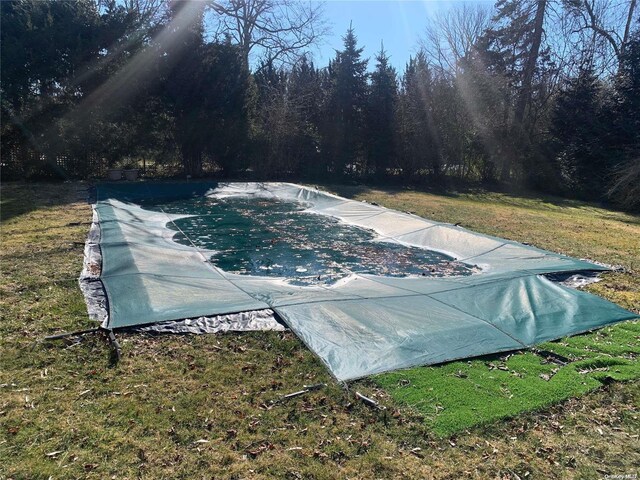 view of pool featuring a yard