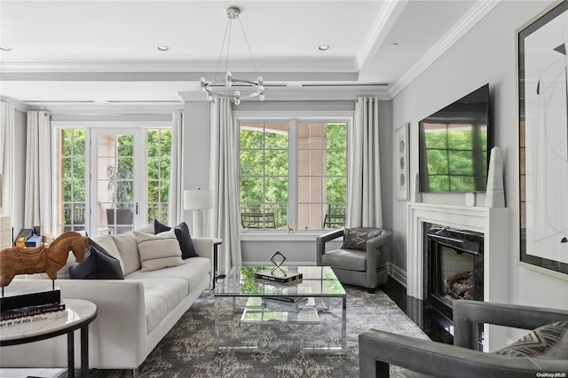 sunroom / solarium featuring french doors, a wealth of natural light, a notable chandelier, and a premium fireplace