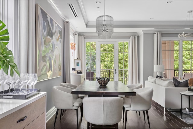 interior space featuring a raised ceiling, an inviting chandelier, and french doors