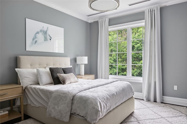 bedroom featuring multiple windows, crown molding, and light carpet