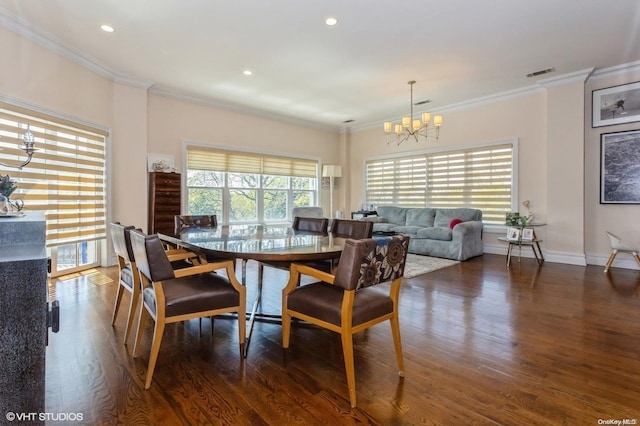 dining area featuring dark hardwood / wood-style flooring, a notable chandelier, and ornamental molding