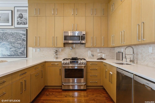 kitchen with appliances with stainless steel finishes, dark hardwood / wood-style flooring, tasteful backsplash, light brown cabinetry, and sink