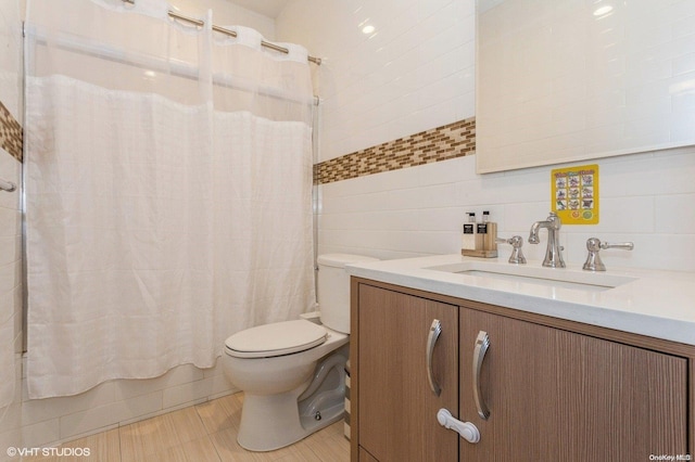 full bathroom featuring shower / bath combo, toilet, tile walls, and vanity