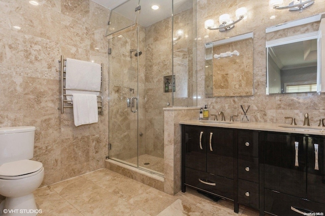 bathroom with vanity, a shower with door, tile walls, radiator heating unit, and toilet