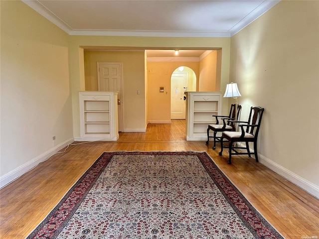 living area featuring hardwood / wood-style floors and ornamental molding