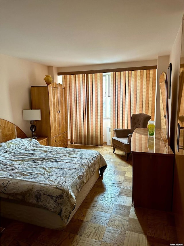 bedroom with light parquet floors