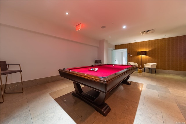 game room with wood walls and billiards