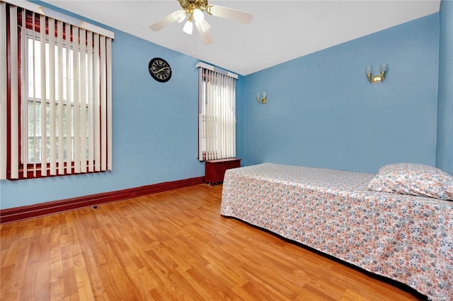 unfurnished bedroom with hardwood / wood-style floors and ceiling fan