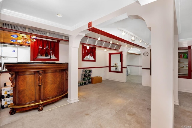 bar with light colored carpet, crown molding, and track lighting