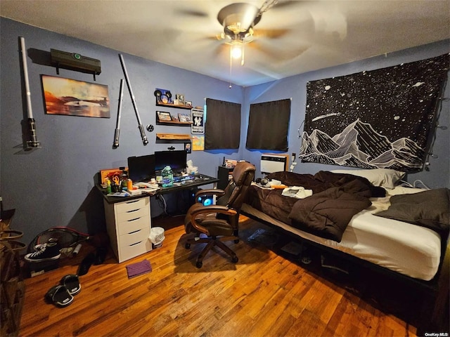 bedroom with ceiling fan and wood-type flooring