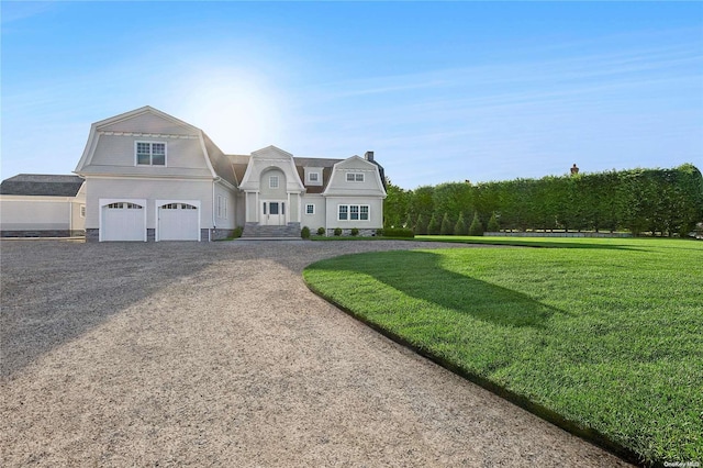 view of front of house featuring a front yard and a garage