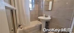 bathroom with shower / tub combo with curtain