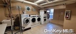 clothes washing area with washing machine and dryer