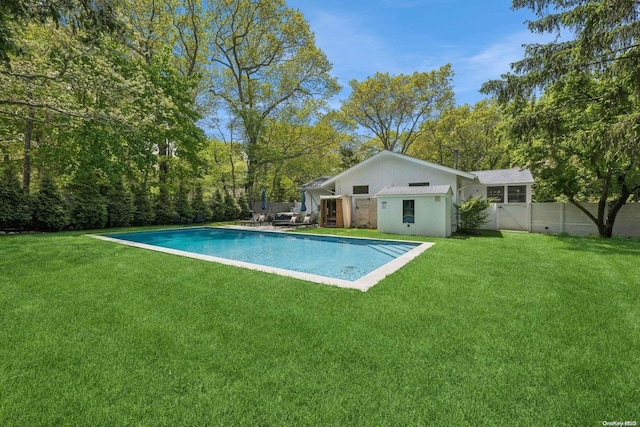 view of pool featuring a lawn