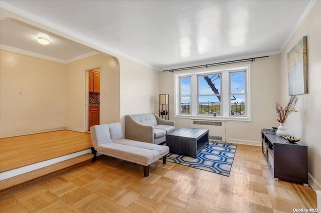 living area featuring radiator, crown molding, and light parquet floors