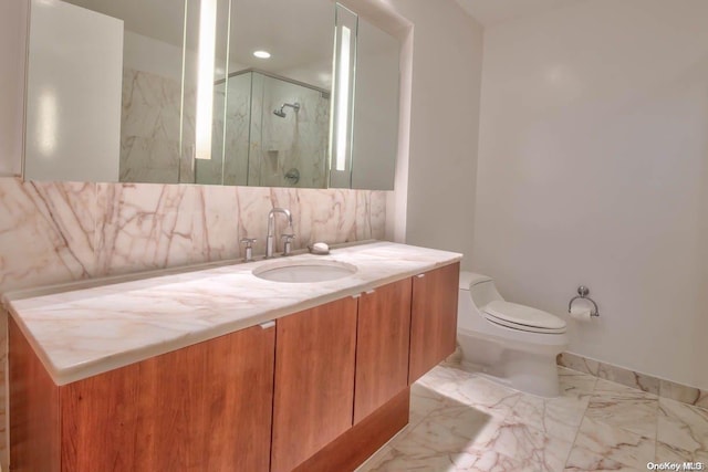 bathroom featuring decorative backsplash, vanity, toilet, and a shower with door