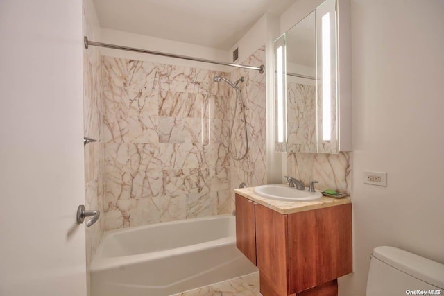 full bathroom featuring toilet, vanity, and tiled shower / bath