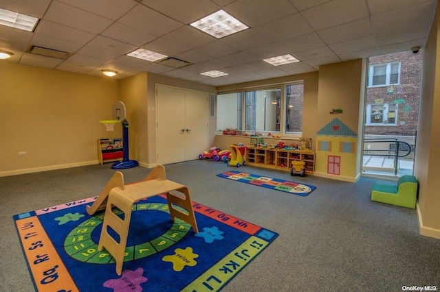 game room with a paneled ceiling and carpet floors