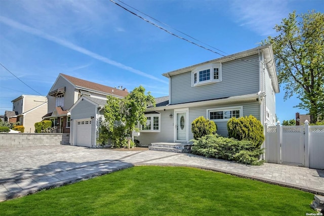 front facade featuring a front lawn and a garage