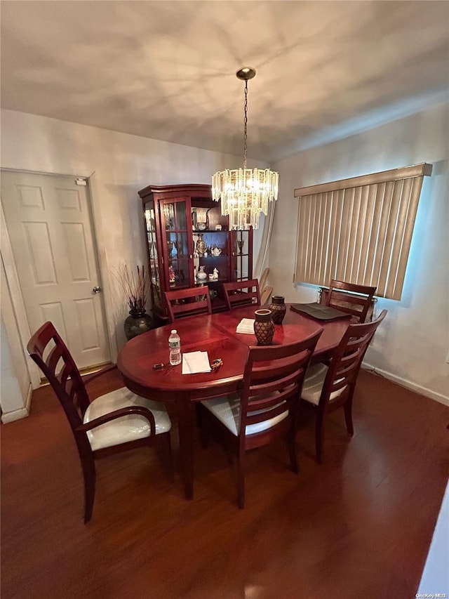 dining area with a chandelier and dark hardwood / wood-style floors