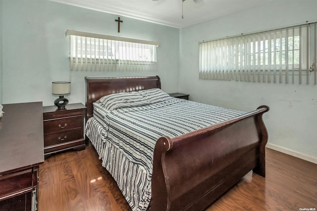 bedroom with dark hardwood / wood-style floors