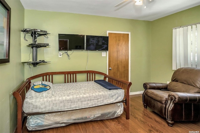 bedroom with ceiling fan and wood-type flooring