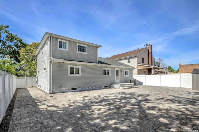 rear view of house with a patio area and central AC