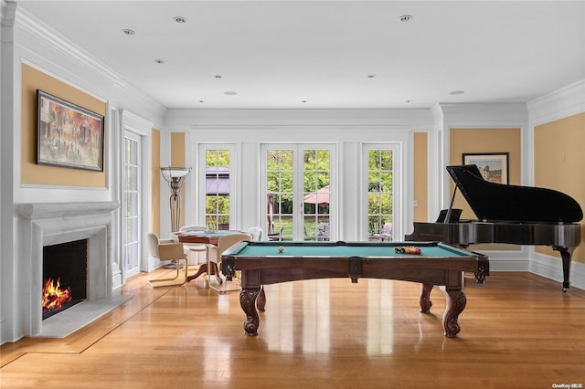 game room with light hardwood / wood-style floors, crown molding, and pool table