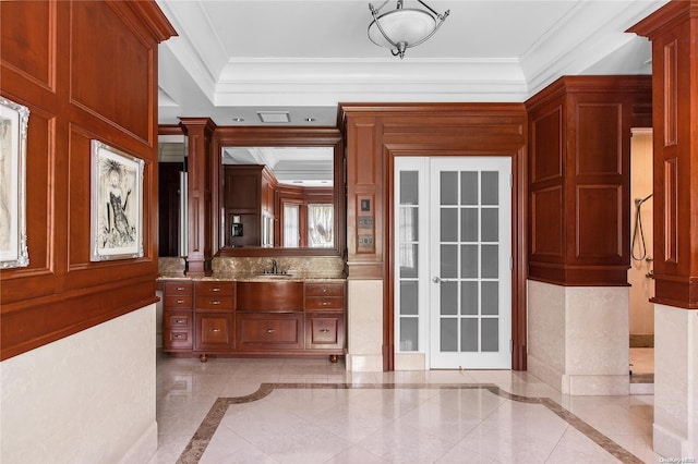 doorway to outside featuring ornate columns and ornamental molding