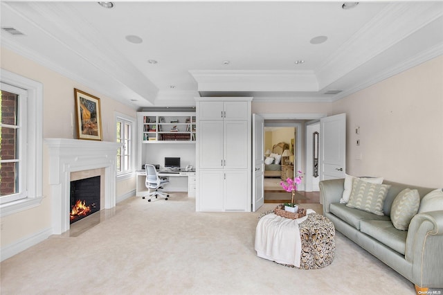 carpeted living room with a raised ceiling, a wealth of natural light, and crown molding