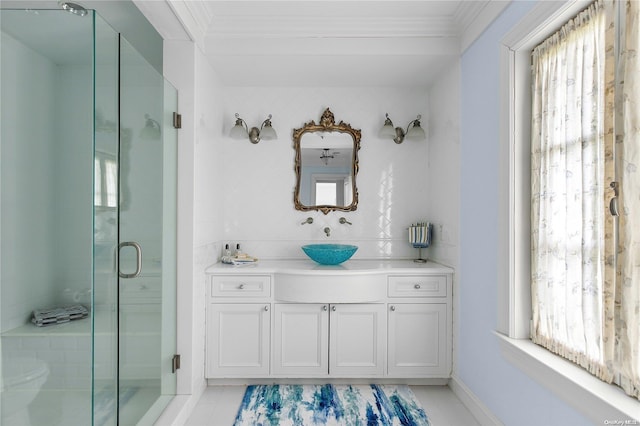 bathroom with tile patterned flooring, vanity, an enclosed shower, and ornamental molding