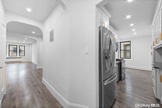 kitchen featuring white cabinets, dark wood-type flooring, and appliances with stainless steel finishes