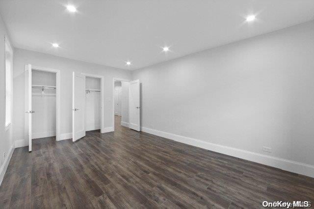 unfurnished bedroom featuring dark hardwood / wood-style flooring