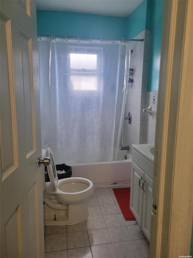 full bathroom with tile patterned floors, shower / tub combo with curtain, vanity, and toilet